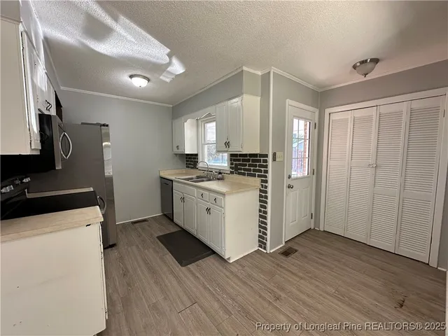 a kitchen with wooden cabinets and white appliances