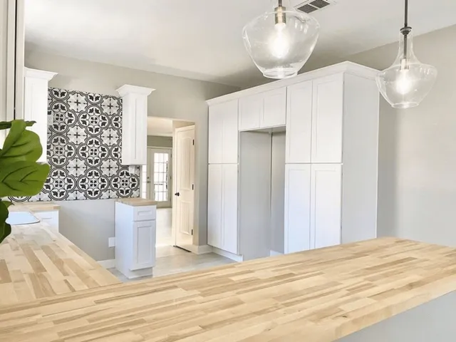 a view of kitchen and empty room