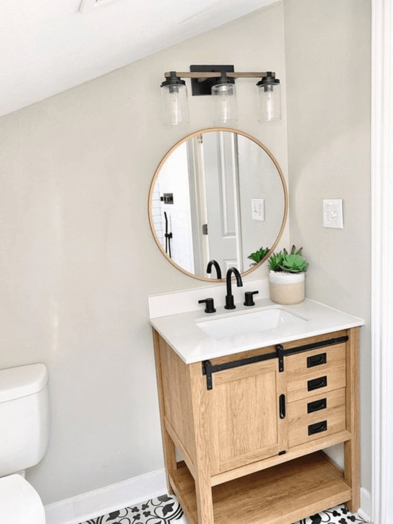 6716 Jefferson Boulevard Groves, TX 77619 - Photo 17 of 34 a bathroom with a sink a toilet and a mirror