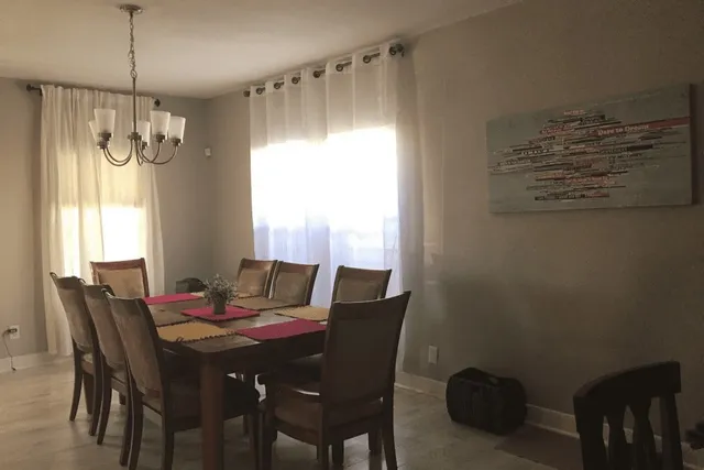 a view of a dining room with furniture window and outside view