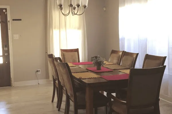 a view of a dining room with furniture and a window