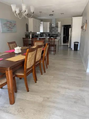 a dining area with furniture and kitchen view