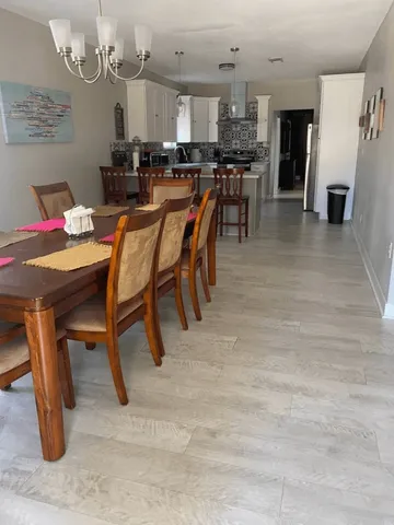 a dining area with furniture and kitchen view