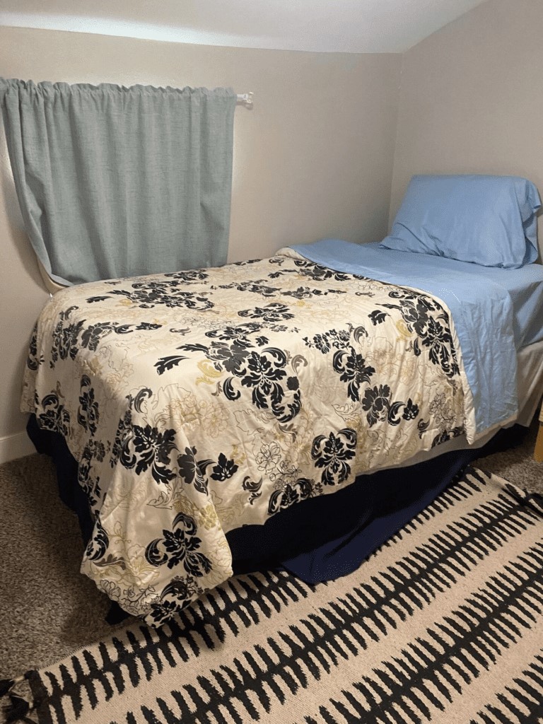 6716 Jefferson Boulevard Groves, TX 77619 - Photo 23 of 34 a bed sitting in a bedroom next to a window