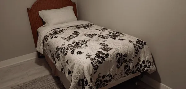 a bed with a black and white comforter