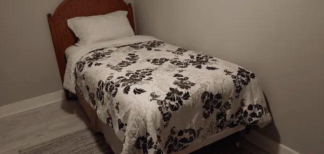 a bed with a black and white comforter