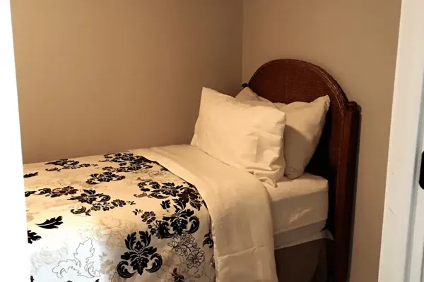a bedroom with a bed and a chair