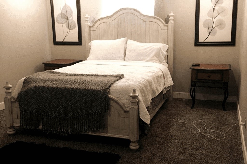 6716 Jefferson Boulevard Groves, TX 77619 - Photo 32 of 34 a bed sitting in a bedroom next to a window