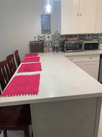 a view of a kitchen with dining table and chairs