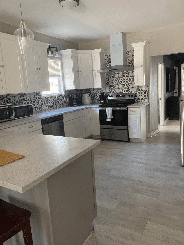 6716 Jefferson Boulevard Groves, TX 77619 - Photo 9 of 34 a kitchen with stainless steel appliances granite countertop a sink and a stove