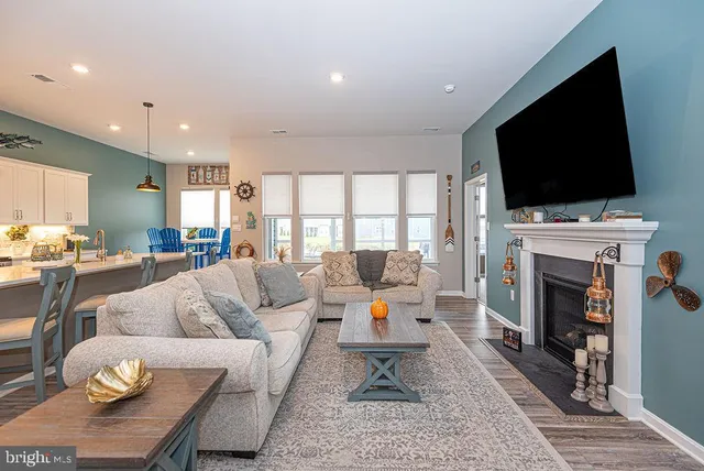 a living room with fireplace furniture and a flat screen tv