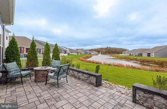 a view of a chairs and table in patio with a lake view