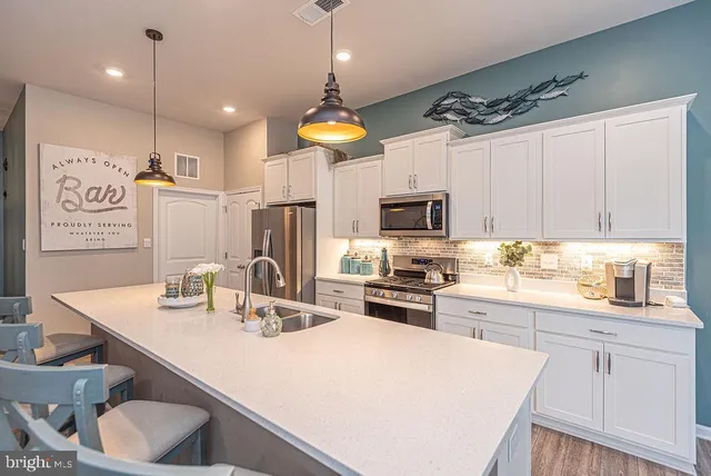 a kitchen with cabinets a sink appliances and a counter top space