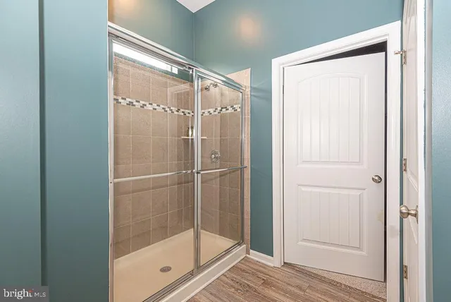 a bathroom with a glass shower door