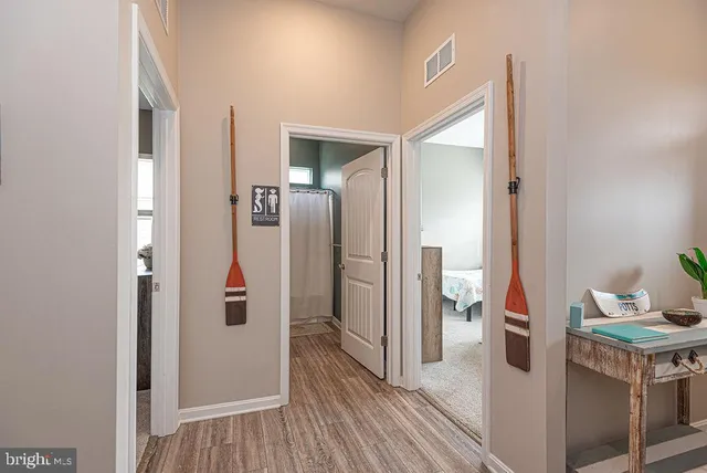 a view of hallway with wooden floor