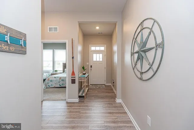 a view of an entryway with wooden floor and a table