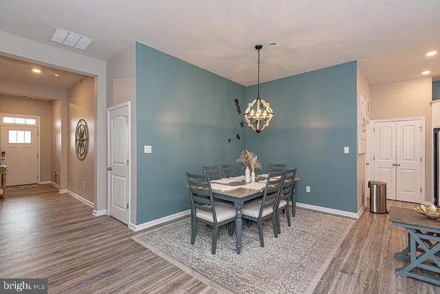 a view of a dining room with furniture wooden floor and a chandelier