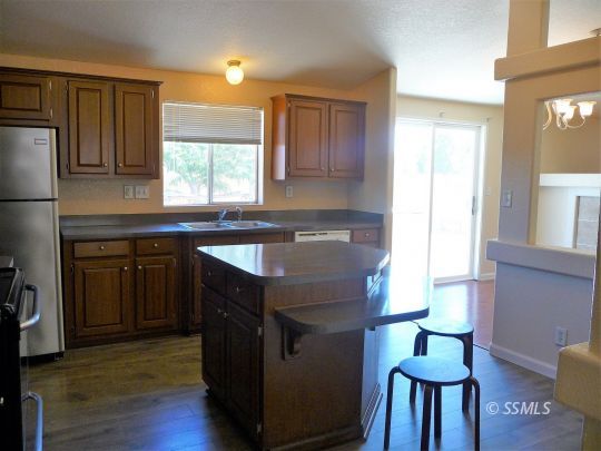 770 Alpine Way Ridgecrest, CA 93555 - Photo 15 of 50 a kitchen with stainless steel appliances granite countertop a sink and a stove