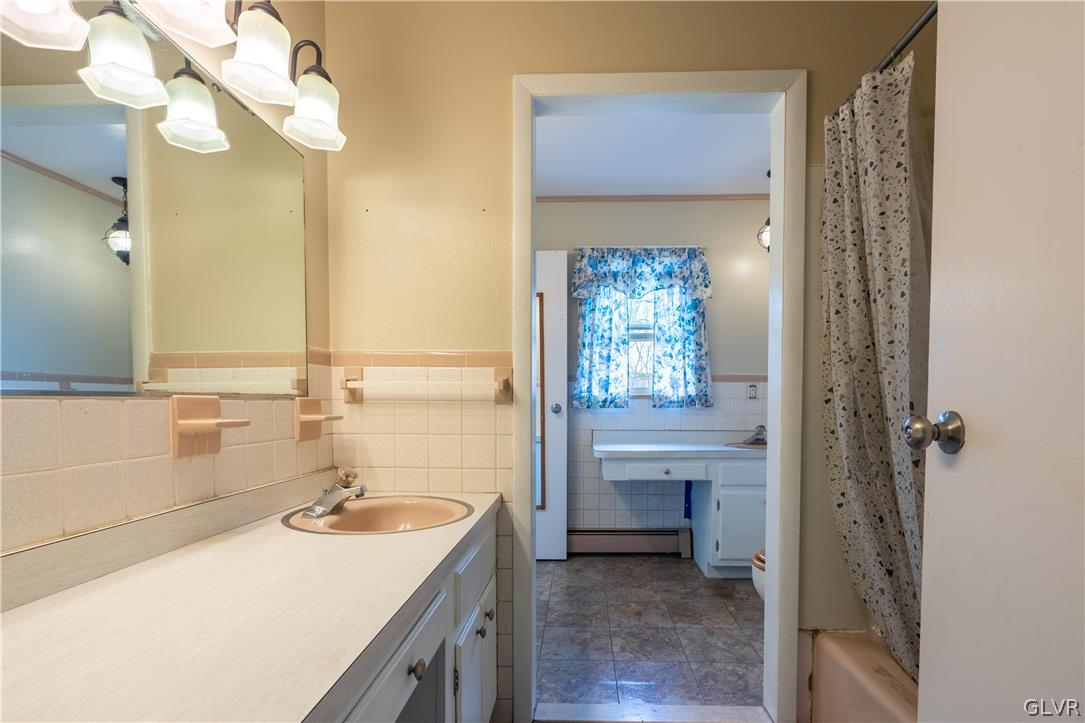 1234 Sunset Circle Slatington, PA 18080 - Photo 30 of 40 a bathroom with a sink a vanity and a mirror