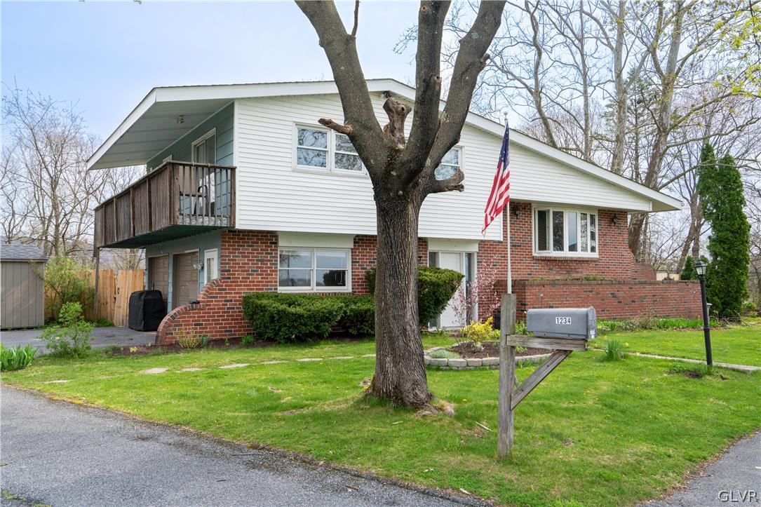 1234 Sunset Circle Slatington, PA 18080 - Photo 3 of 40 a front view of a house with a yard and tree