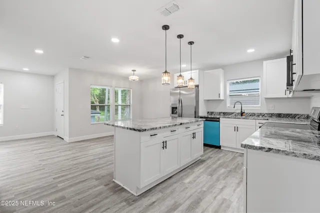 a bathroom with a granite countertop toilet sink and mirror