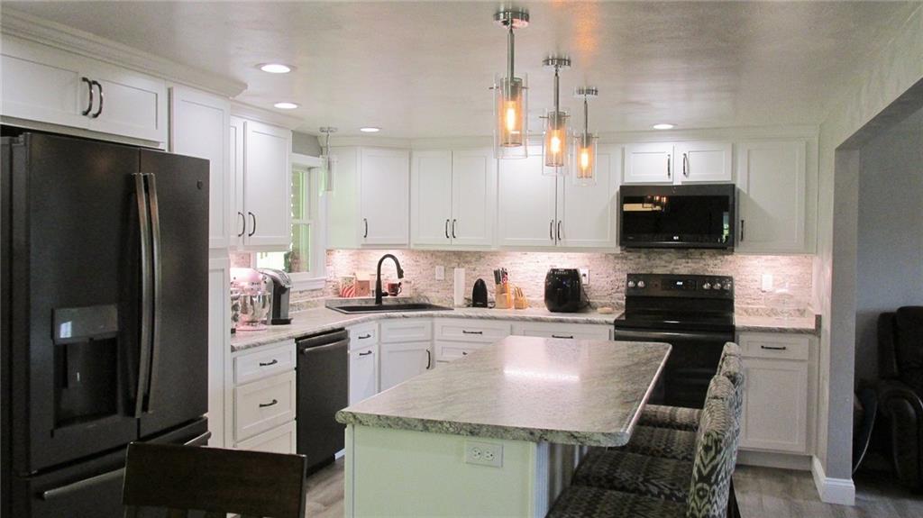 236 Freeman Road Irwin, PA 15642 - Photo 8 of 24 Functional and impressive new lighting...gorgeous backsplash....and touch control faucet with extra deep sink!!