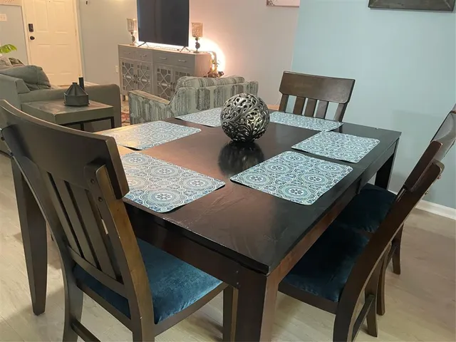 a view of a dining room with furniture and wooden floor