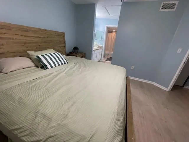 a bedroom with a bed and a mirror