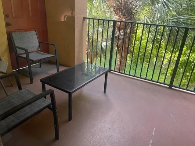 a view of a hallway with furniture and floor to ceiling window