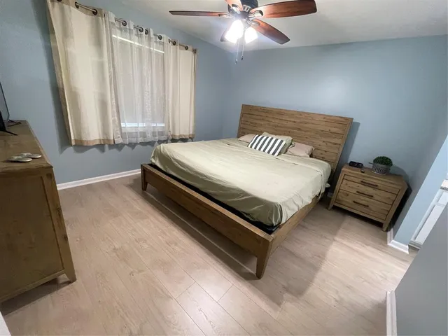 a bedroom with a bed window and a flat screen tv