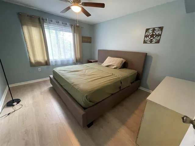 a bed sitting in a bedroom next to a window