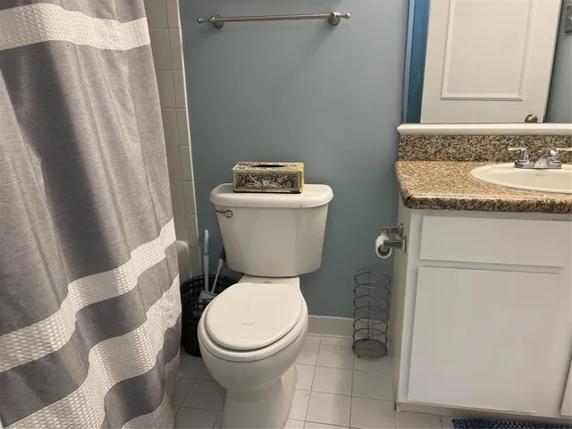 a white toilet sitting next to a bathroom sink