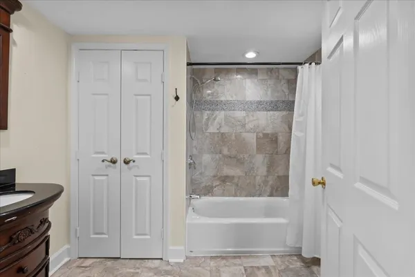 a bathroom with a bathtub and a shower