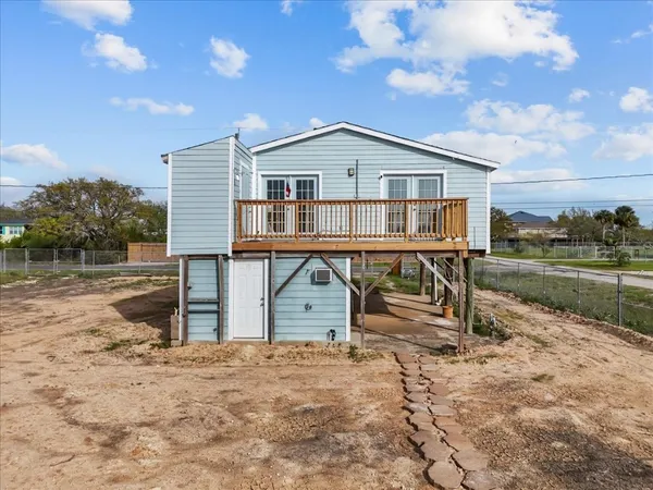 a front view of a house with a wooden deck