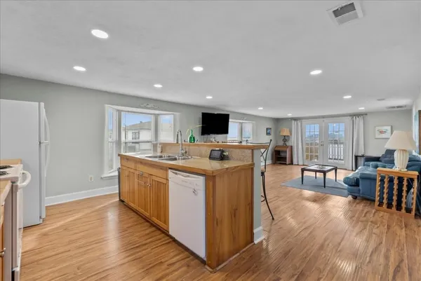 a kitchen with stainless steel appliances kitchen island granite countertop a stove and a refrigerator