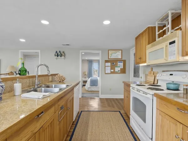 a kitchen with stainless steel appliances granite countertop a stove and a refrigerator