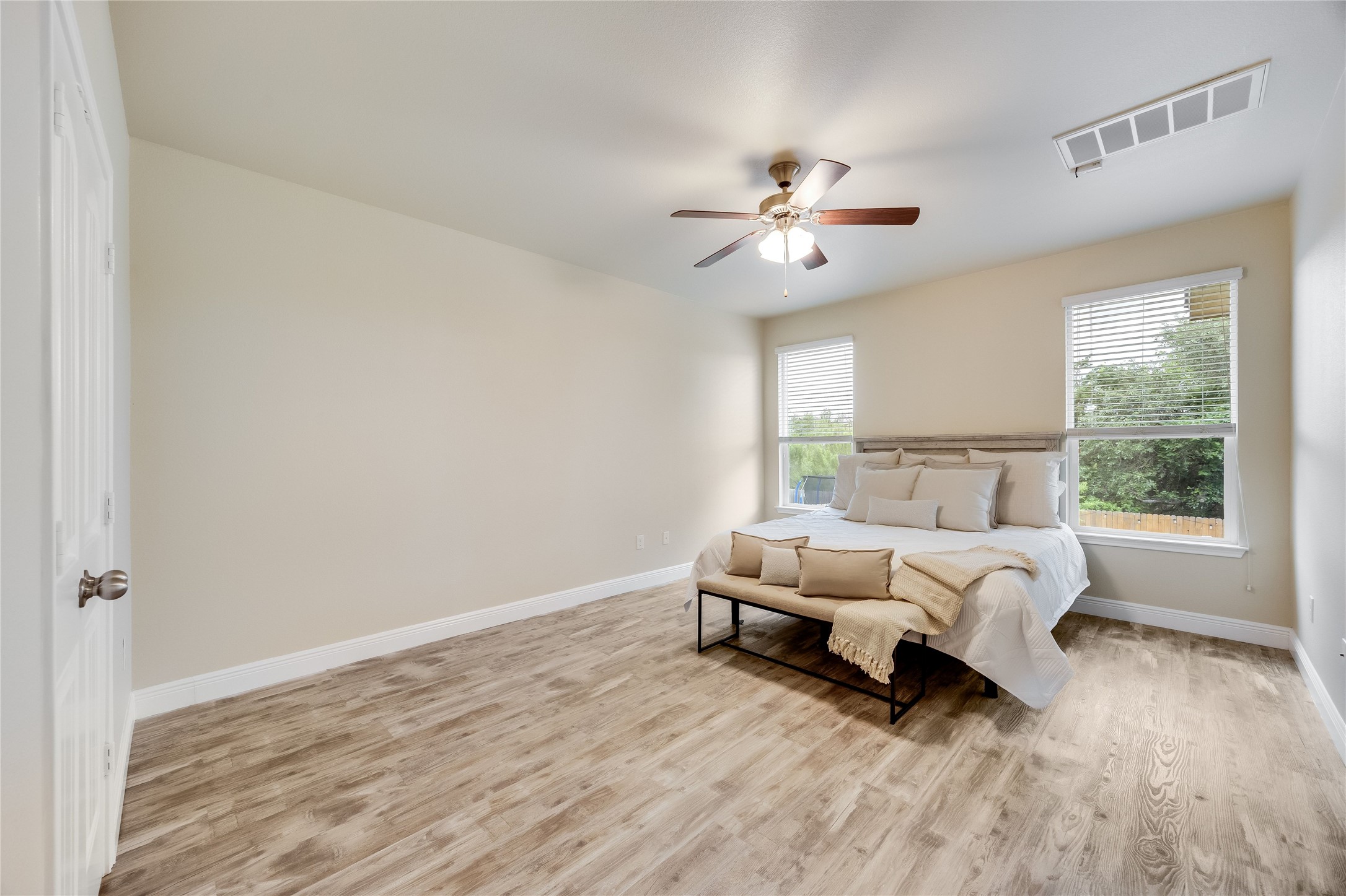 11328 Reading Way Austin, TX 78717 - Photo 16 of 37 a spacious bedroom with a bed and a window