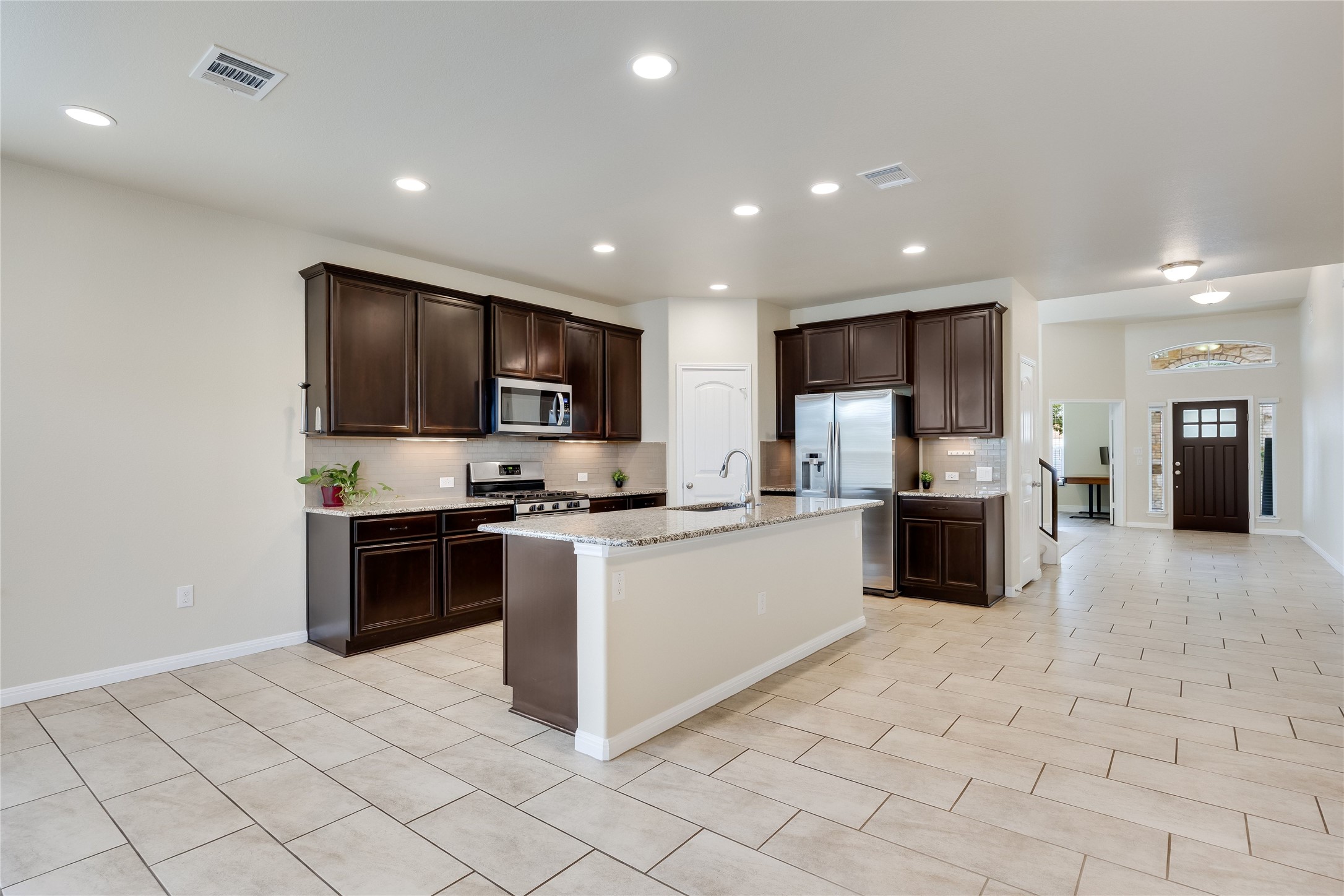 11328 Reading Way Austin, TX 78717 - Photo 7 of 37 a kitchen with stainless steel appliances granite countertop a refrigerator stove top oven and sink
