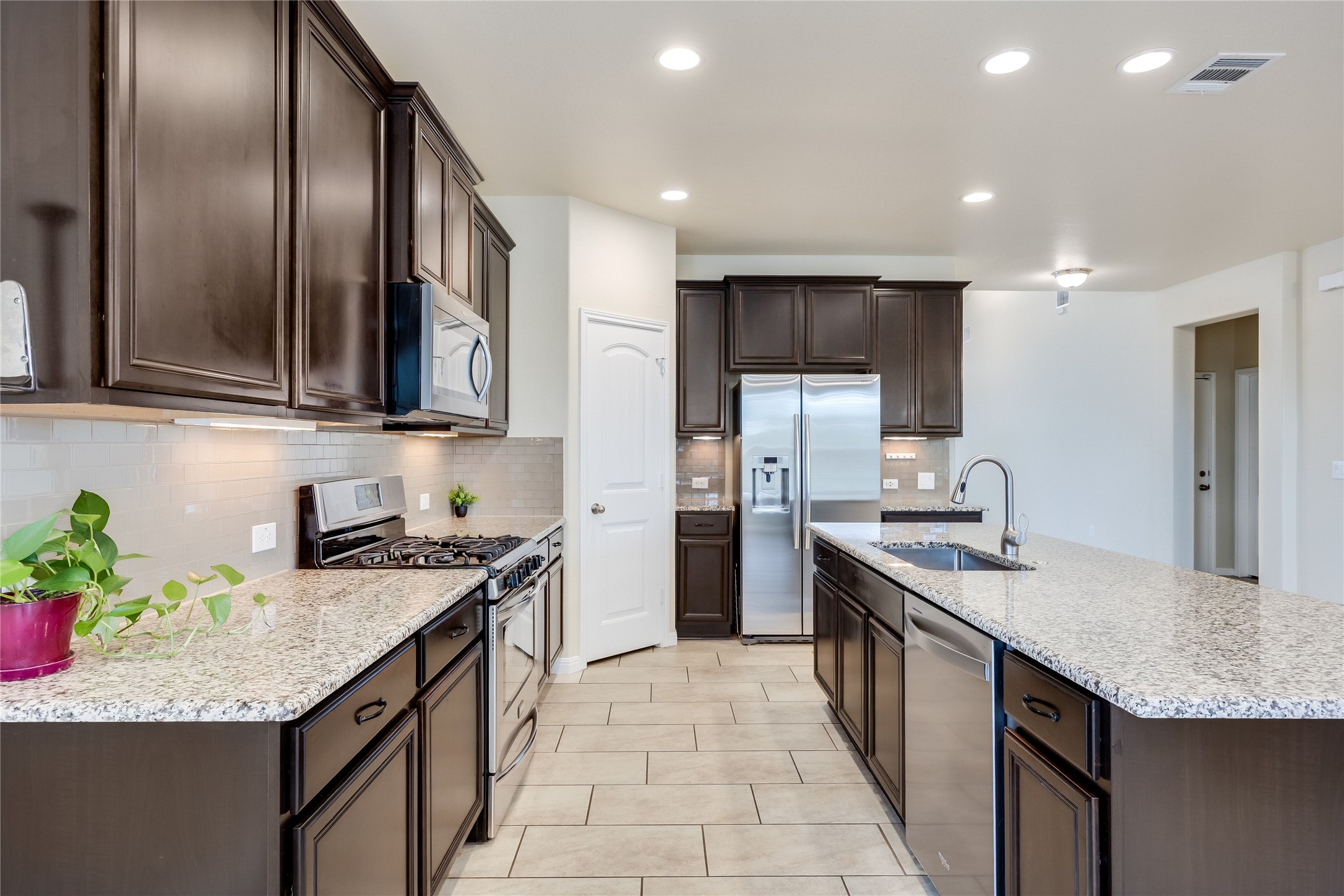 11328 Reading Way Austin, TX 78717 - Photo 8 of 37 a kitchen with stainless steel appliances granite countertop a sink a stove and a refrigerator