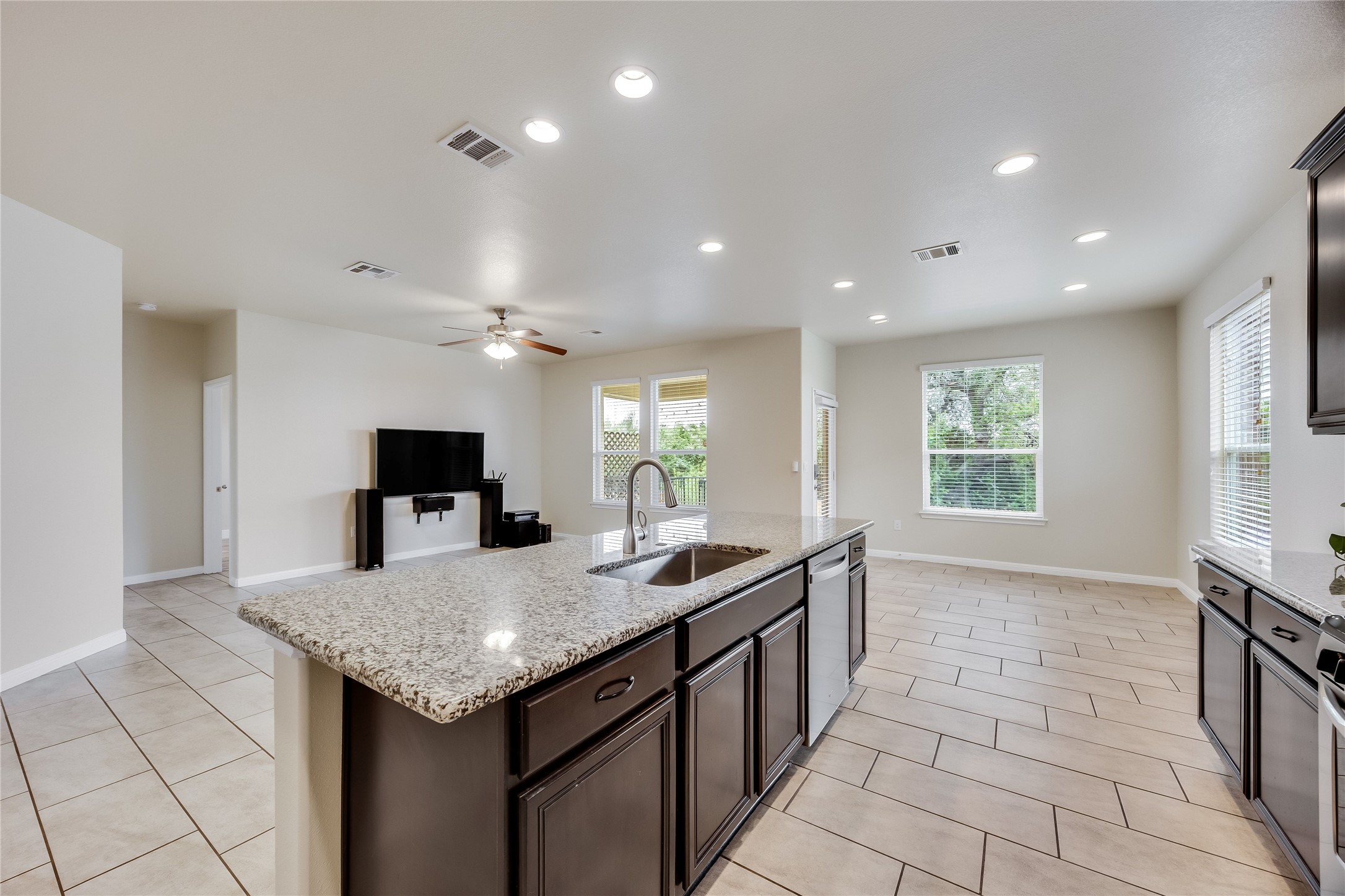 11328 Reading Way Austin, TX 78717 - Photo 10 of 37 a kitchen with granite countertop a sink and a stove