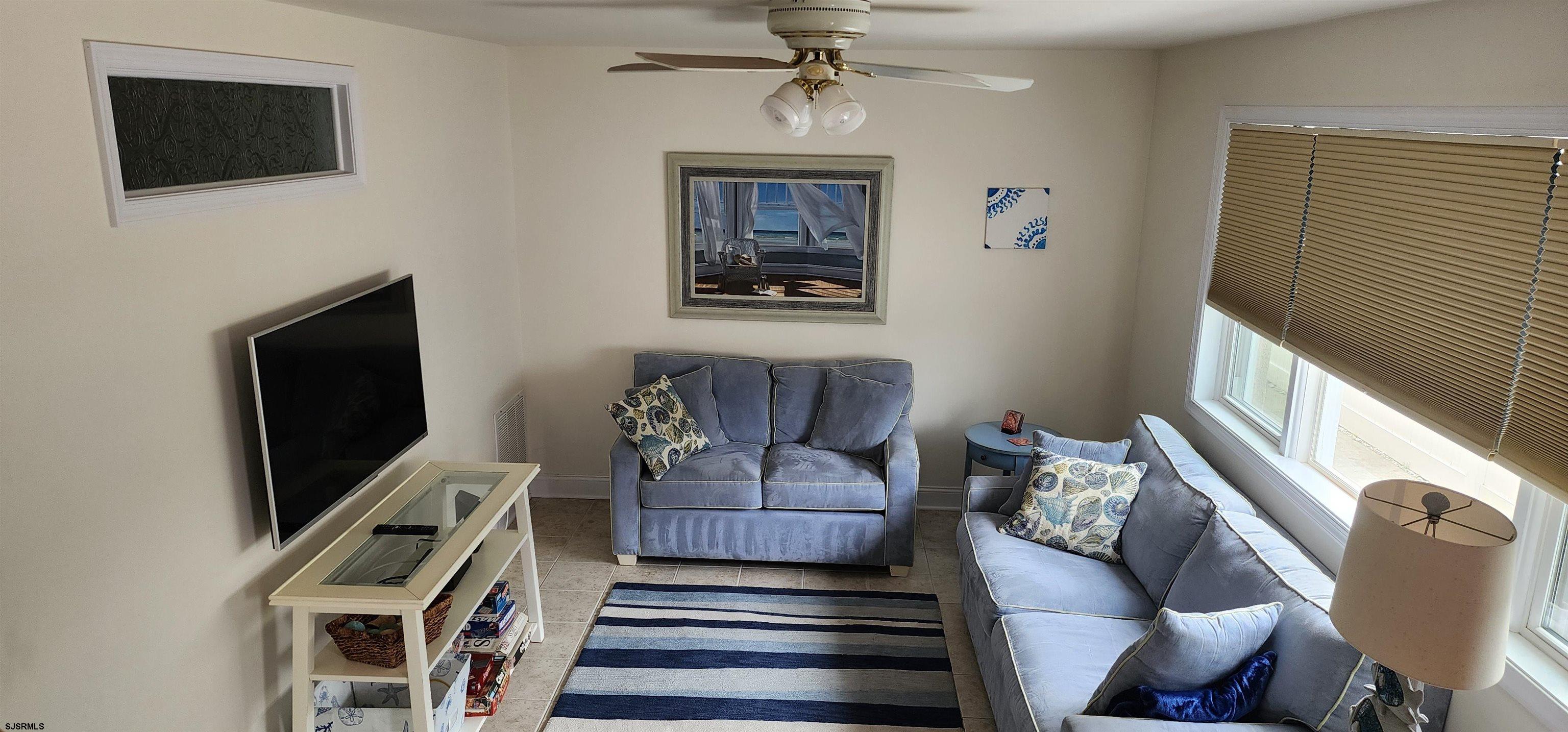 4313 West Brigantine Avenue, Unit 3 Brigantine, NJ 08203 - Photo 3 of 15 a living room with furniture and a flat screen tv