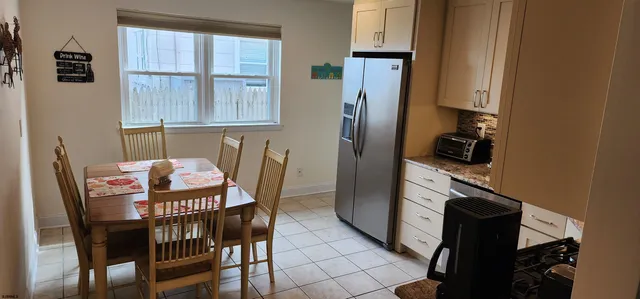 a kitchen with stainless steel appliances kitchen island granite countertop a stove a sink and a microwave