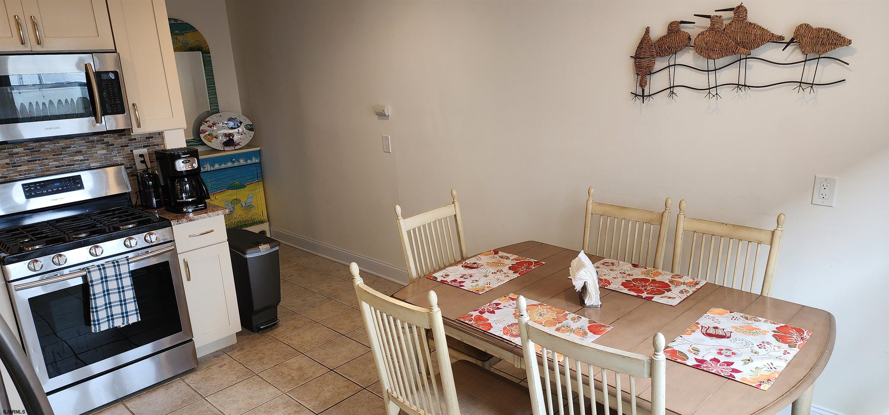 4313 West Brigantine Avenue, Unit 3 Brigantine, NJ 08203 - Photo 5 of 15 a kitchen with stainless steel appliances kitchen island granite countertop a stove a sink and a microwave