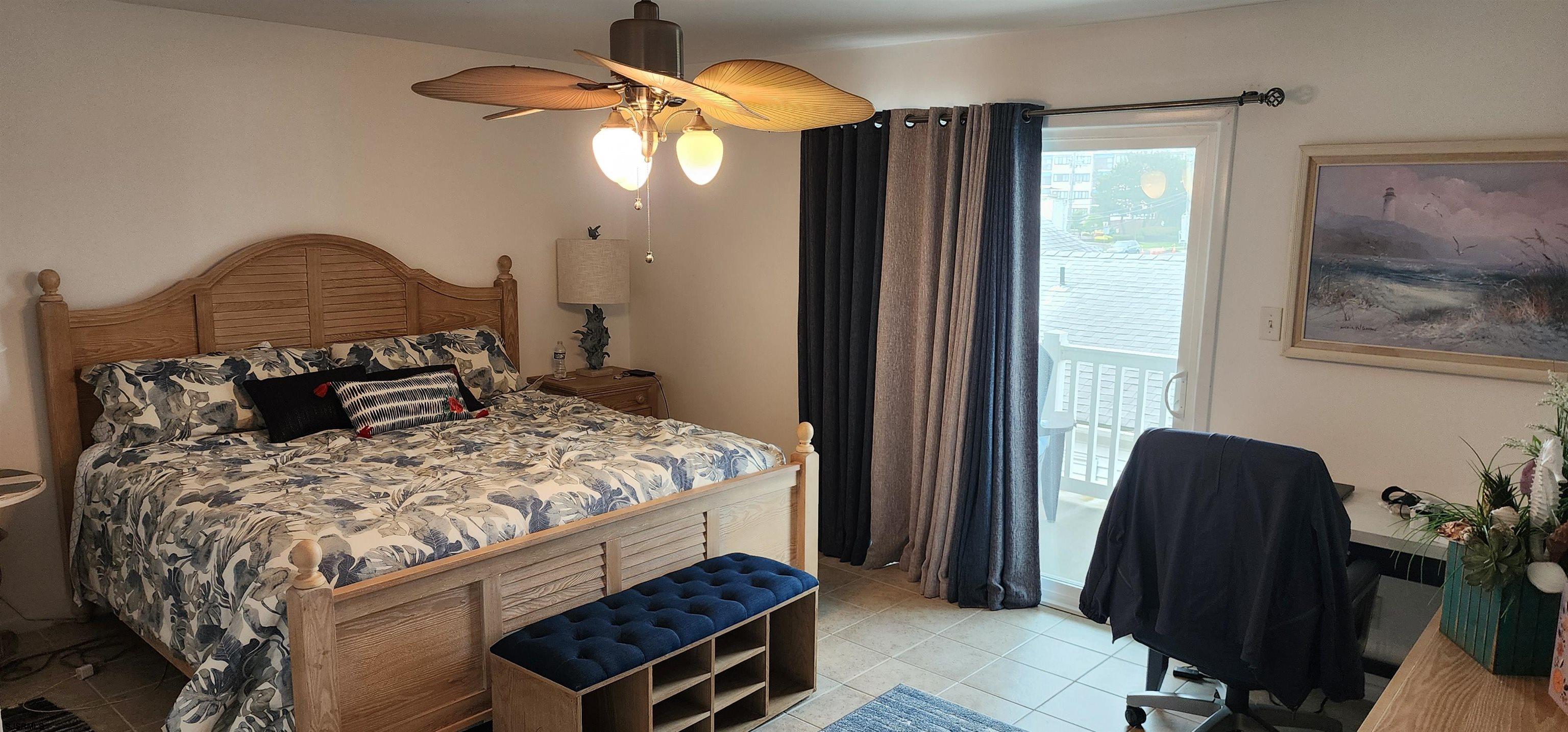 4313 West Brigantine Avenue, Unit 3 Brigantine, NJ 08203 - Photo 7 of 15 a bedroom with a bed and a chandelier