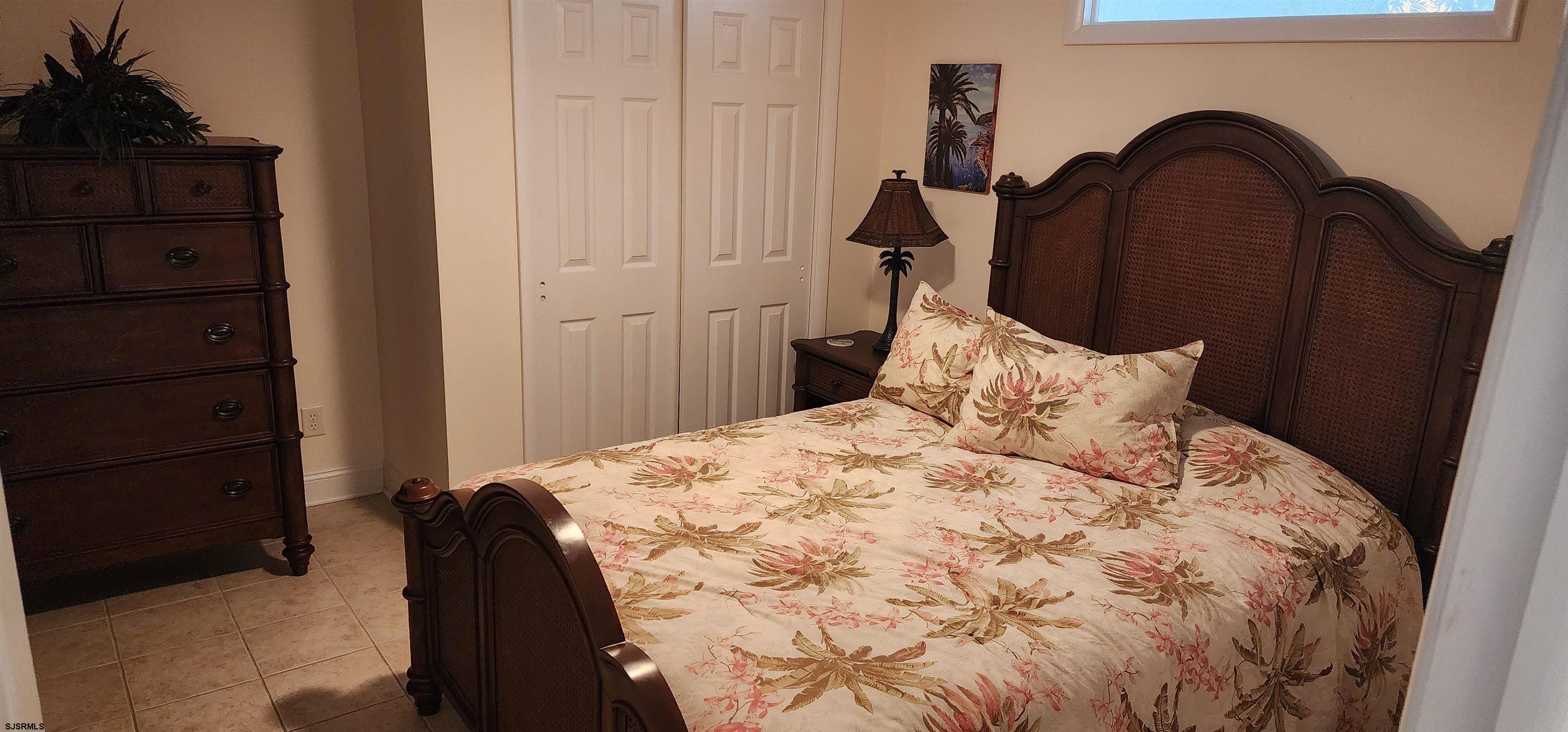 4313 West Brigantine Avenue, Unit 3 Brigantine, NJ 08203 - Photo 8 of 15 a bedroom with a bed and a dresser next to a window