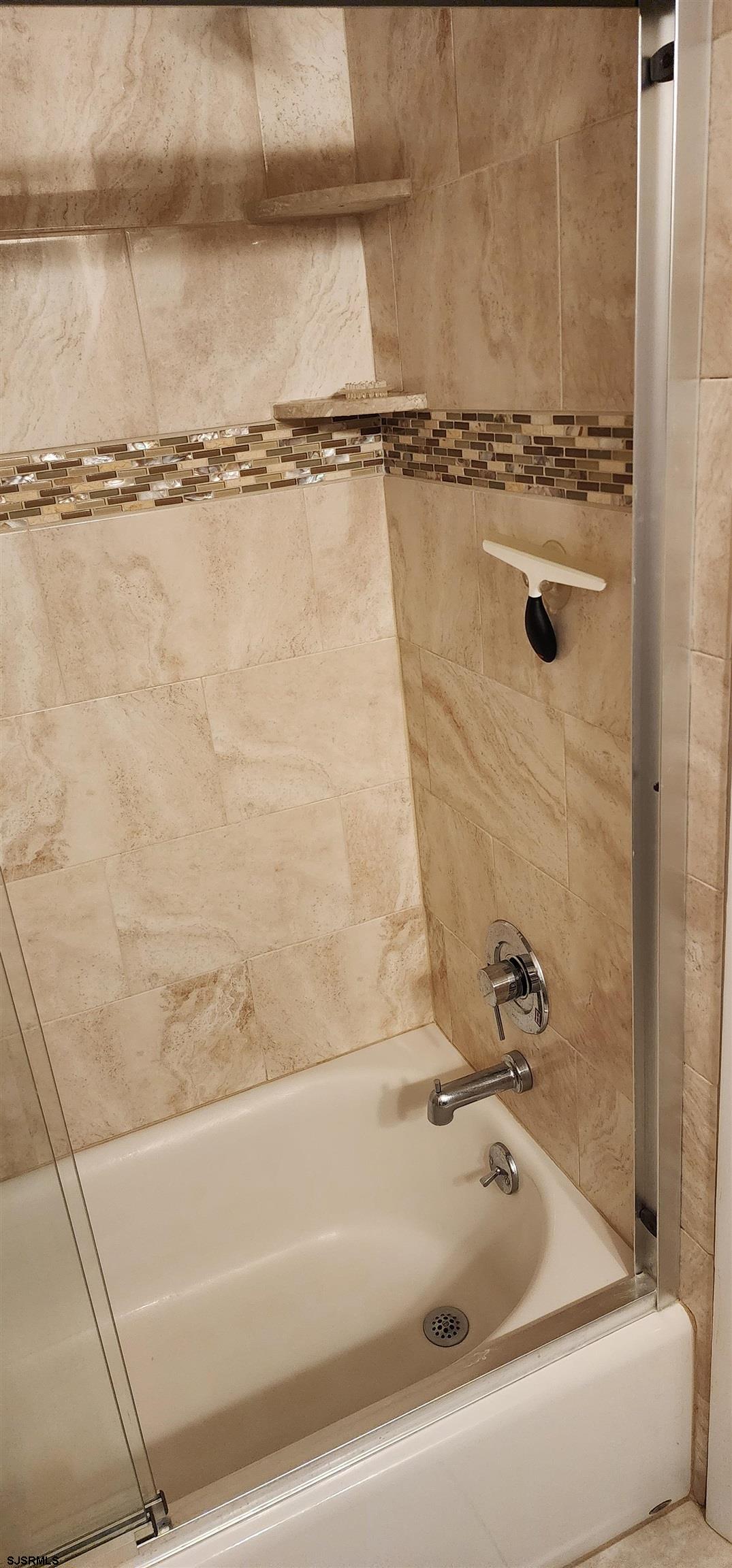 4313 West Brigantine Avenue, Unit 3 Brigantine, NJ 08203 - Photo 10 of 15 a bathroom with a tub and a shower