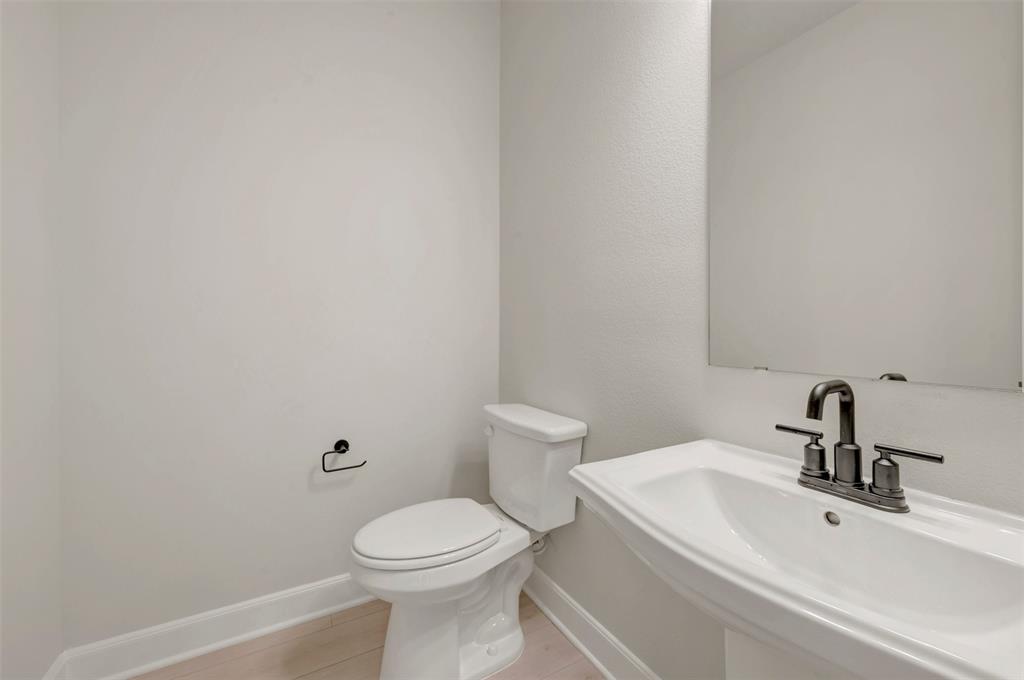 4308 Palomino Road Aubrey, TX 76227 - Photo 10 of 40 a bathroom with a sink a toilet and mirror