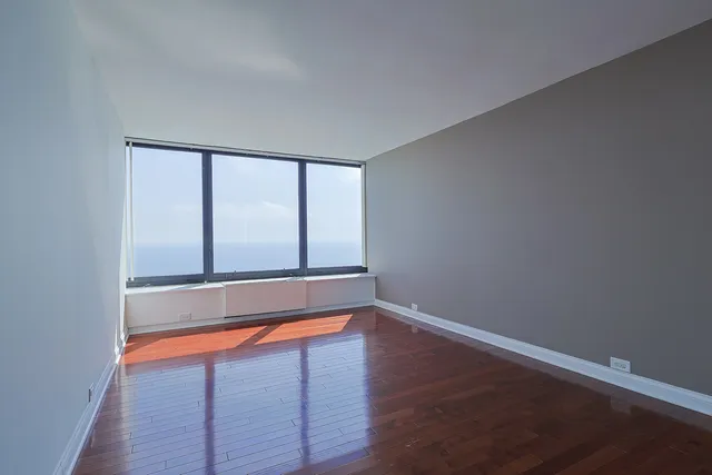 a view of room with window and wooden floor