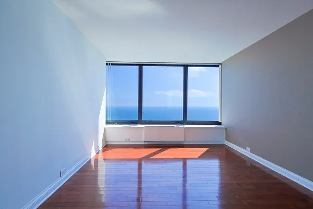 a room with wooden floor and pool table