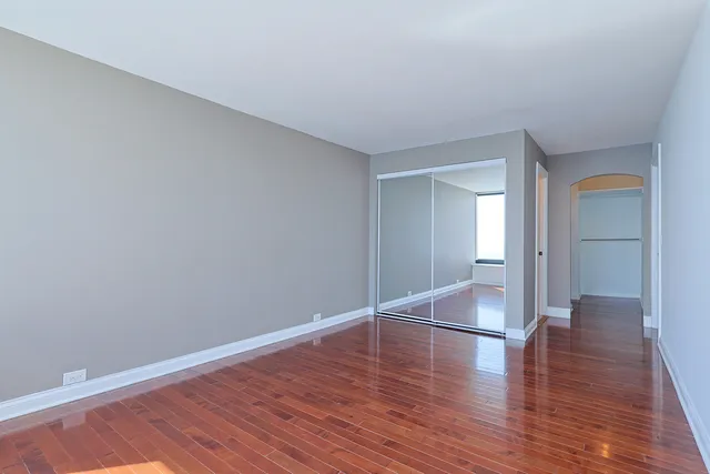 a view of wooden floor and windows in a room